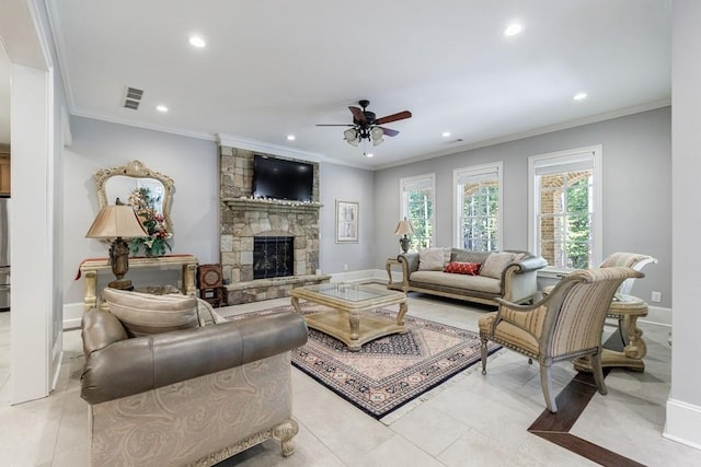 tiled living room with ceiling fan, a fireplace, and crown molding