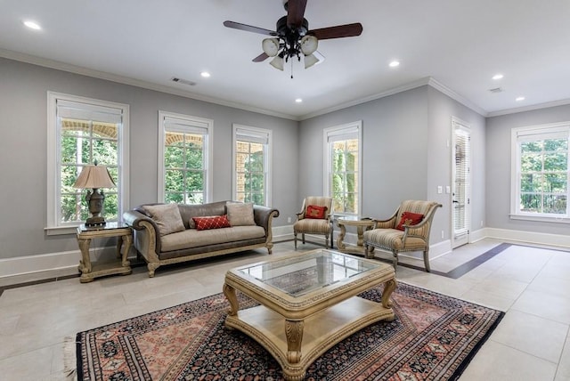 living room with a healthy amount of sunlight, ceiling fan, light tile patterned floors, and crown molding