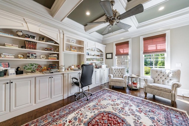 office area with ceiling fan, beam ceiling, dark wood-type flooring, built in desk, and ornamental molding