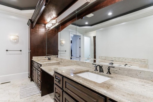 bathroom with ornamental molding, a tray ceiling, and vanity