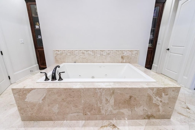 bathroom featuring tiled tub