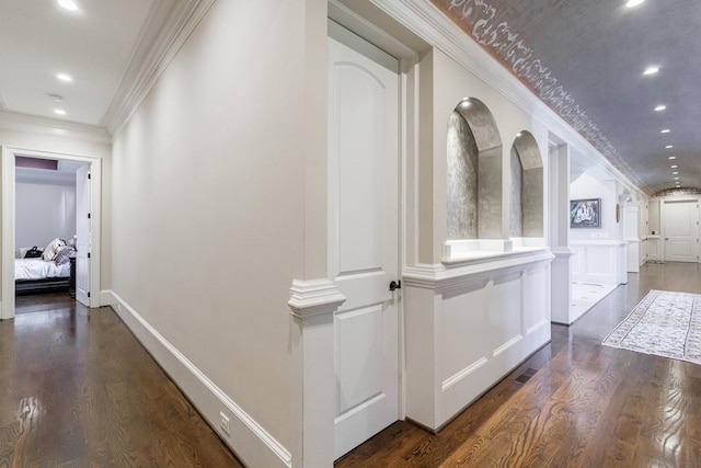 hall with crown molding and dark hardwood / wood-style flooring