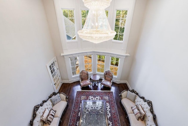 living room featuring plenty of natural light, a chandelier, and dark hardwood / wood-style flooring