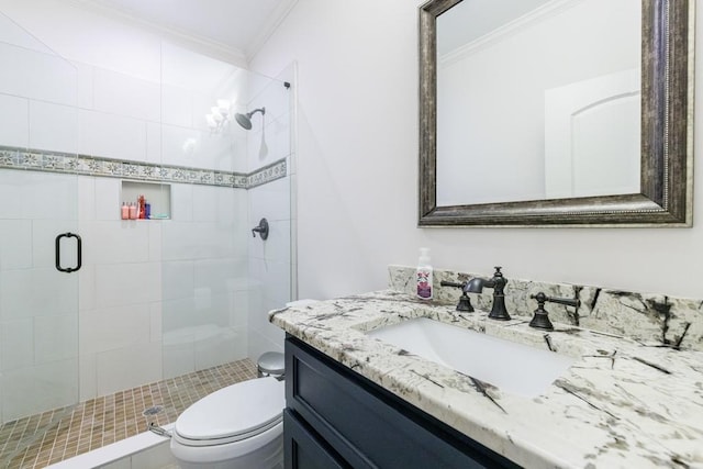 bathroom with crown molding, a shower with door, vanity, and toilet