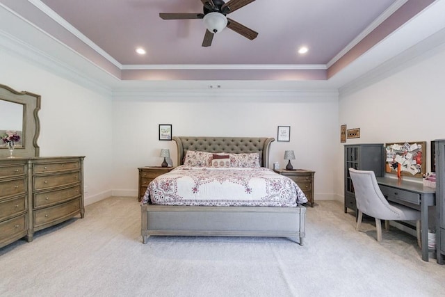 bedroom with ceiling fan, light colored carpet, a tray ceiling, and ornamental molding