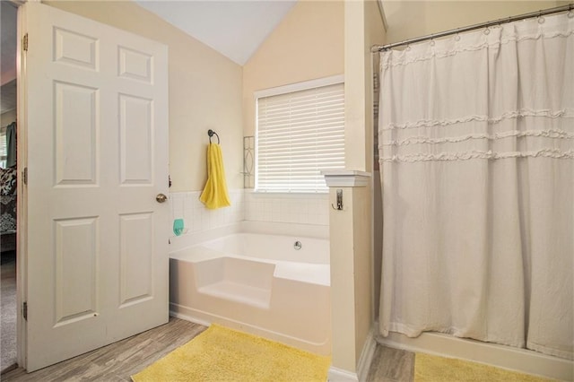 bathroom with hardwood / wood-style flooring, independent shower and bath, and lofted ceiling