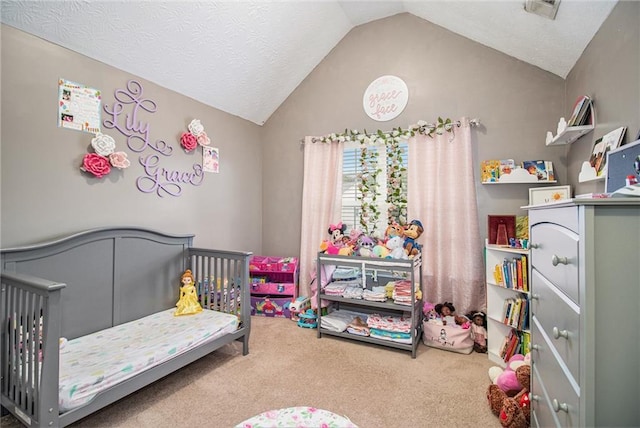 carpeted bedroom with a nursery area and vaulted ceiling