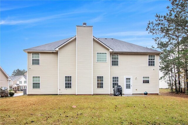 rear view of house with a yard