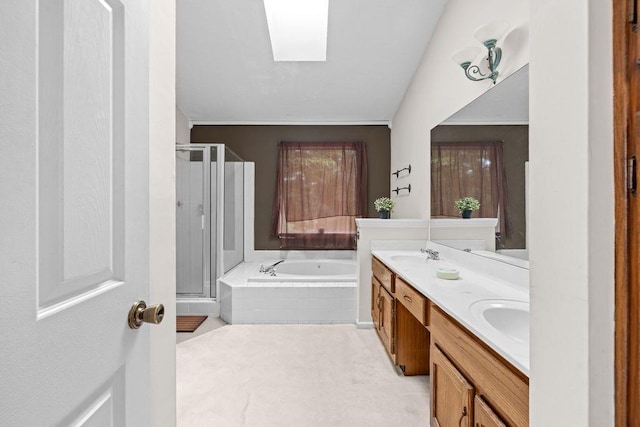 bathroom with vanity, shower with separate bathtub, and a skylight