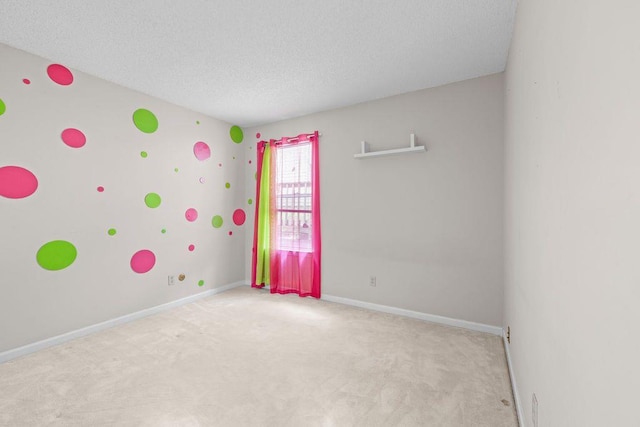 carpeted spare room featuring a textured ceiling