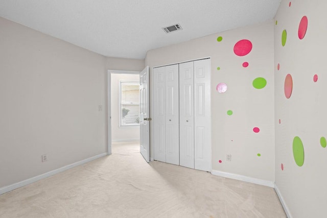 unfurnished bedroom with light colored carpet