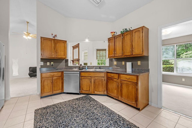 kitchen featuring ceiling fan, stainless steel dishwasher, sink, and light carpet