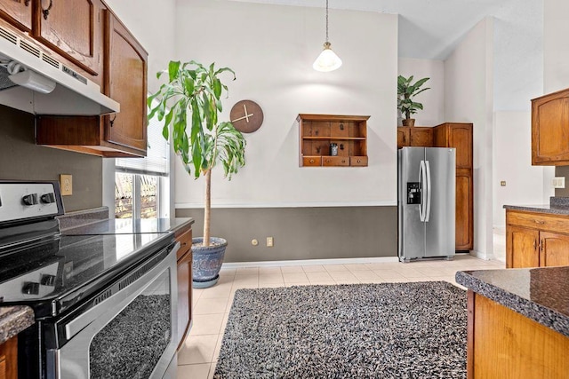 kitchen with light tile patterned floors, decorative light fixtures, and stainless steel appliances