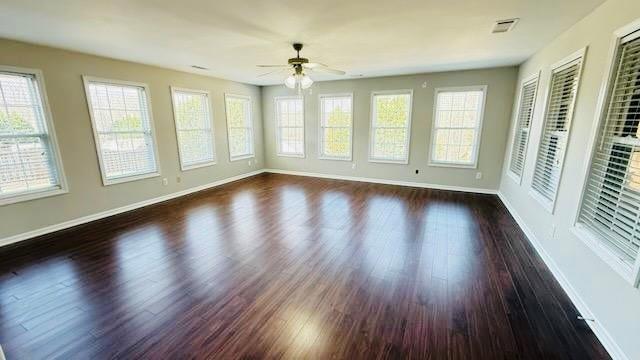 unfurnished sunroom with a ceiling fan