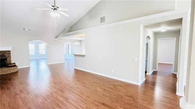 interior space with a fireplace, high vaulted ceiling, and dark hardwood / wood-style floors