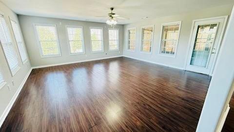 unfurnished sunroom featuring a ceiling fan