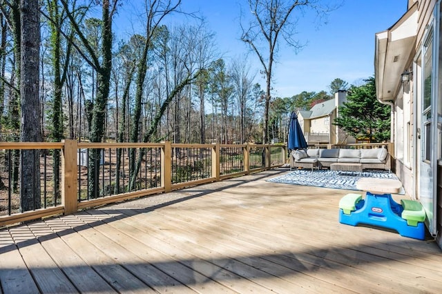 wooden terrace featuring outdoor lounge area