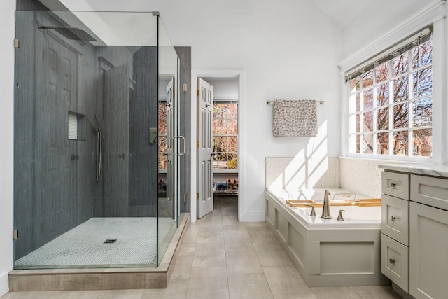 full bath featuring a stall shower, tile patterned flooring, a garden tub, and vaulted ceiling
