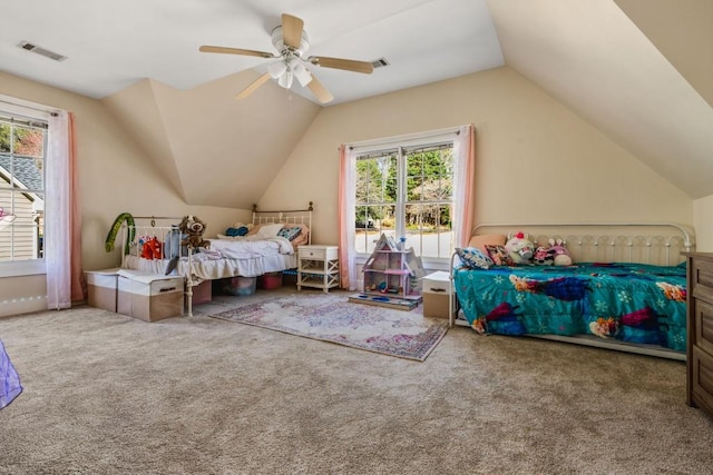 carpeted bedroom with lofted ceiling, ceiling fan, and visible vents