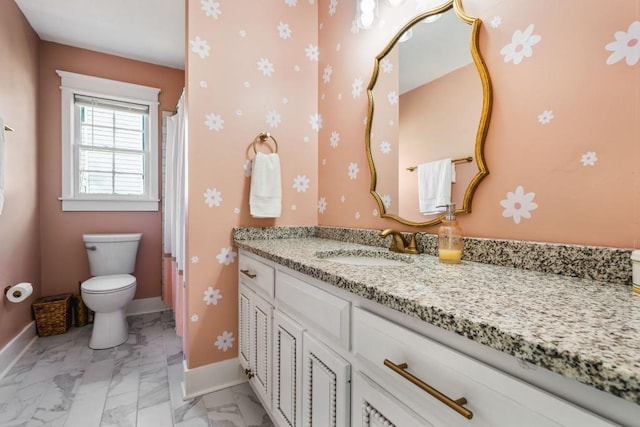full bath featuring baseboards, marble finish floor, vanity, and toilet