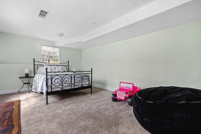 carpeted bedroom featuring baseboards and visible vents