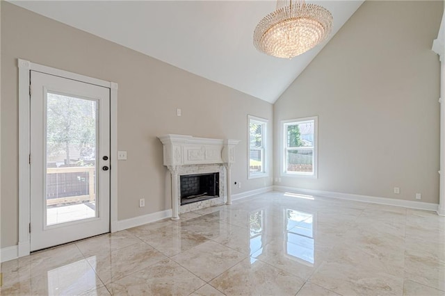 unfurnished living room featuring high vaulted ceiling and a chandelier