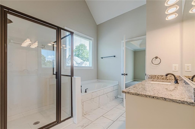 bathroom featuring vanity, separate shower and tub, and vaulted ceiling