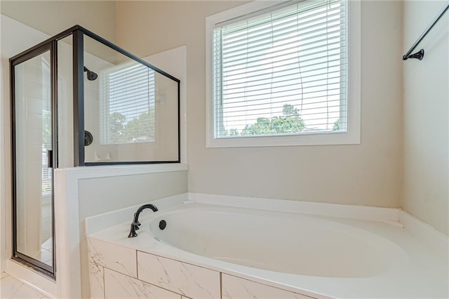 bathroom featuring separate shower and tub and a wealth of natural light