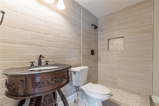 bathroom featuring walk in shower, toilet, and tile walls