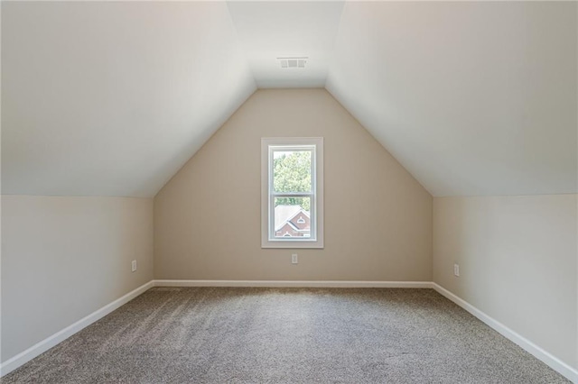 bonus room with carpet and vaulted ceiling