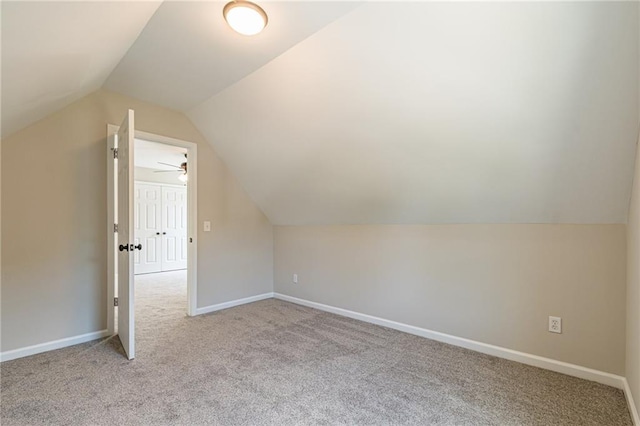 bonus room with light carpet, ceiling fan, and lofted ceiling