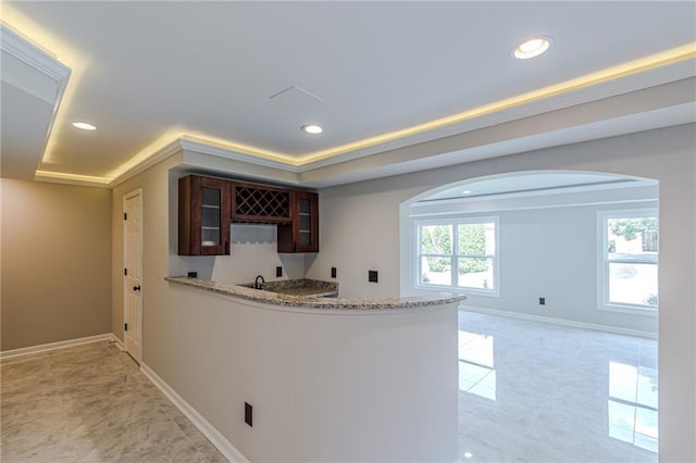 kitchen with a raised ceiling and ornamental molding