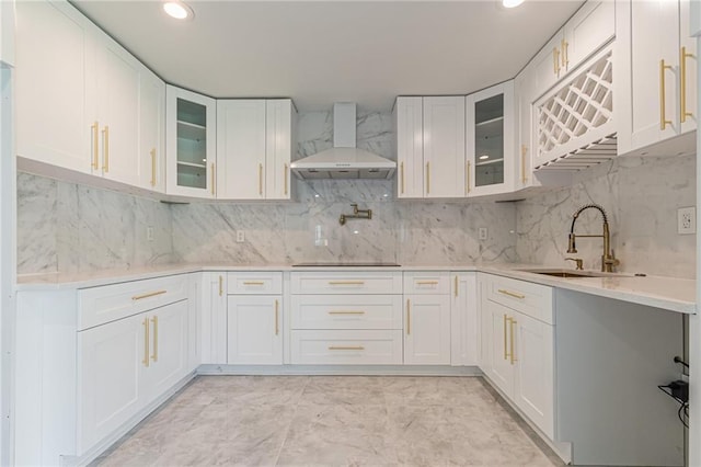 kitchen with white cabinets, sink, and wall chimney exhaust hood