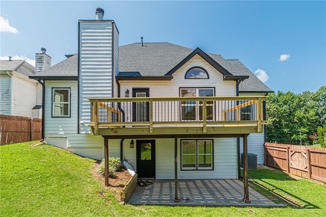 rear view of house with a deck, a yard, and a patio