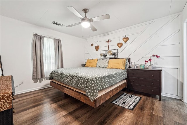 bedroom featuring baseboards, ceiling fan, wood finished floors, and visible vents