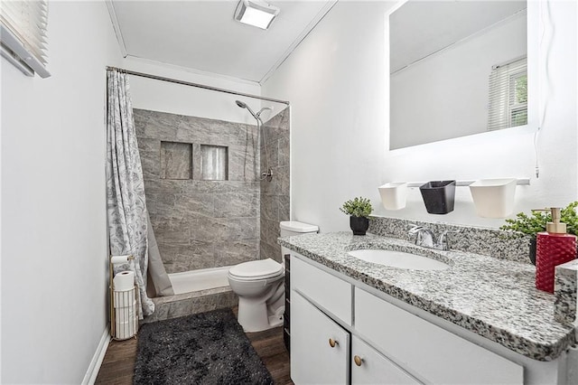 bathroom with vanity, toilet, ornamental molding, and a stall shower