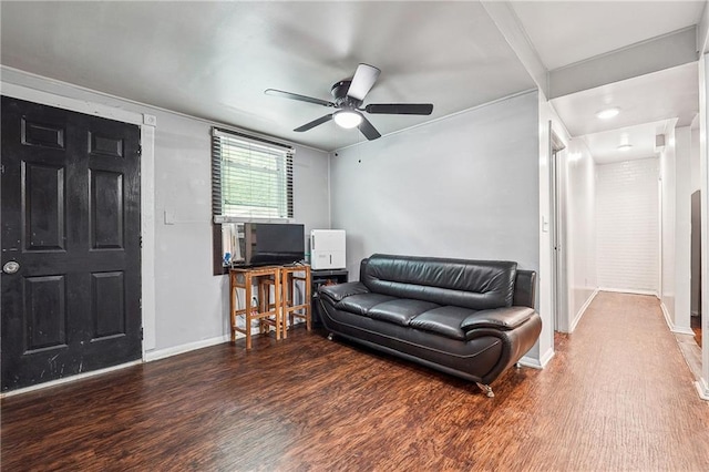living room with baseboards, a ceiling fan, and wood finished floors