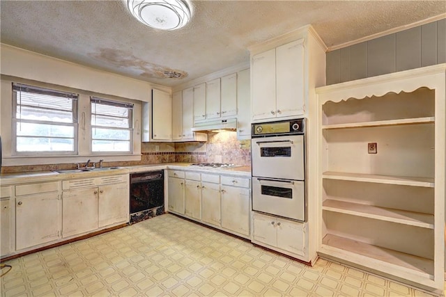 6191 Cumming Hwy, Canton, GA 30115 - kitchen with black dishwasher, white double oven, a sink, light flooring, and a textured ceiling