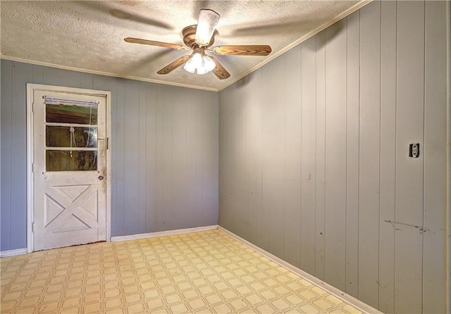 6191 Cumming Hwy, Canton, GA 30115 - spare room featuring tile patterned floors, ceiling fan, crown molding, wooden walls, and a textured ceiling