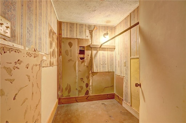 6191 Cumming Hwy, Canton, GA 30115 - bathroom featuring a textured ceiling, wallpapered walls, baseboards, and concrete floors