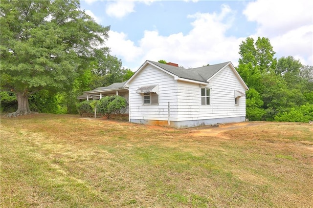 6191 Cumming Hwy, Canton, GA 30115 - view of side of home with a yard and a chimney