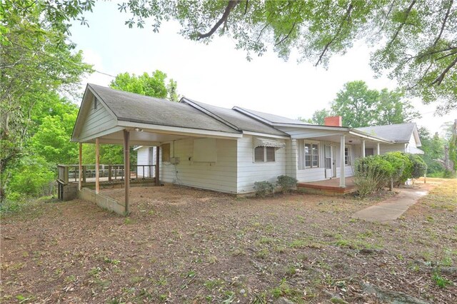 6191 Cumming Hwy, Canton, GA 30115 - view of front of house with an attached carport, covered porch, and a chimney
