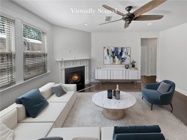 living room featuring ceiling fan and hardwood / wood-style flooring