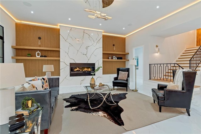 living room featuring stairs, recessed lighting, and a fireplace