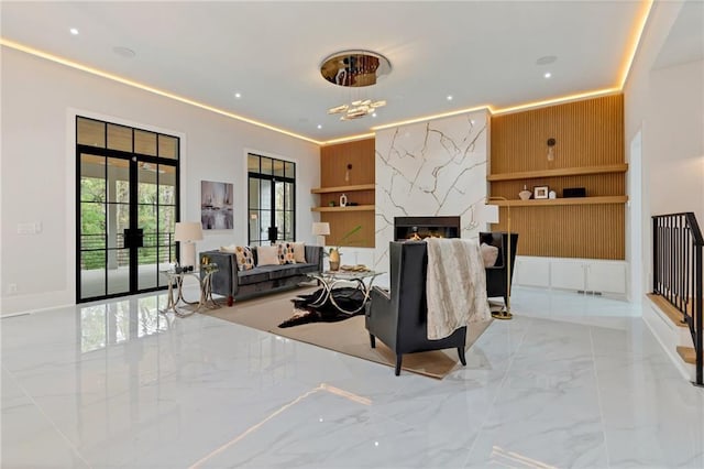 living area with recessed lighting, baseboards, marble finish floor, and a high end fireplace