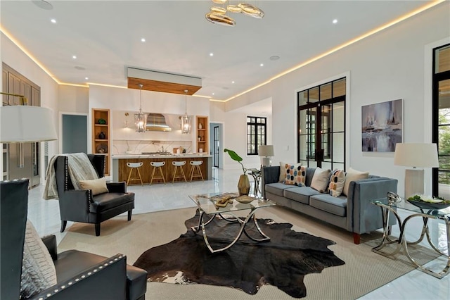 living room featuring a notable chandelier and recessed lighting