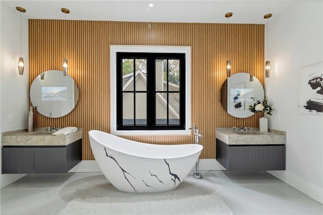 bathroom featuring a soaking tub and two vanities