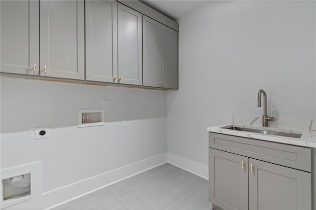 laundry room featuring electric dryer hookup, washer hookup, a sink, cabinet space, and baseboards