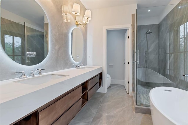 full bath featuring a shower stall, marble finish floor, and a sink