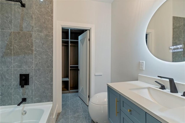 bathroom with tile patterned flooring, walk in shower, toilet, a bathing tub, and vanity